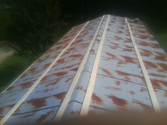 Rusted metal roof panels with new wood purlins before replacement — Storm Damage Roof Repair in Peachland by Roofing Brothers